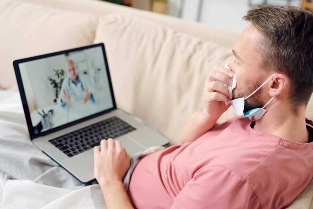 Man consulting doctor via video call.